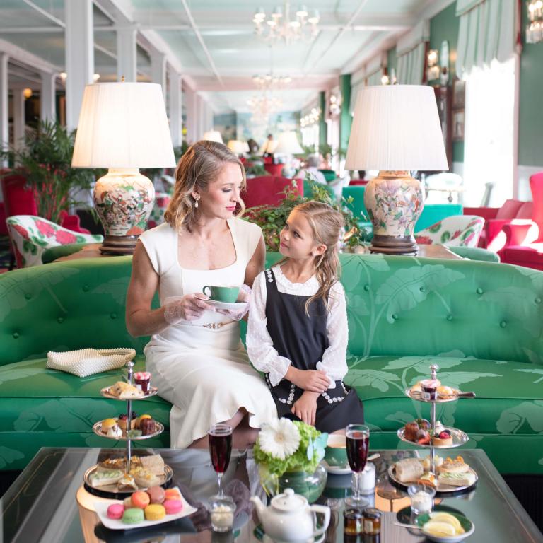 Mom and daughter enjoying afternoon tea in the parlor at Grand Hotel