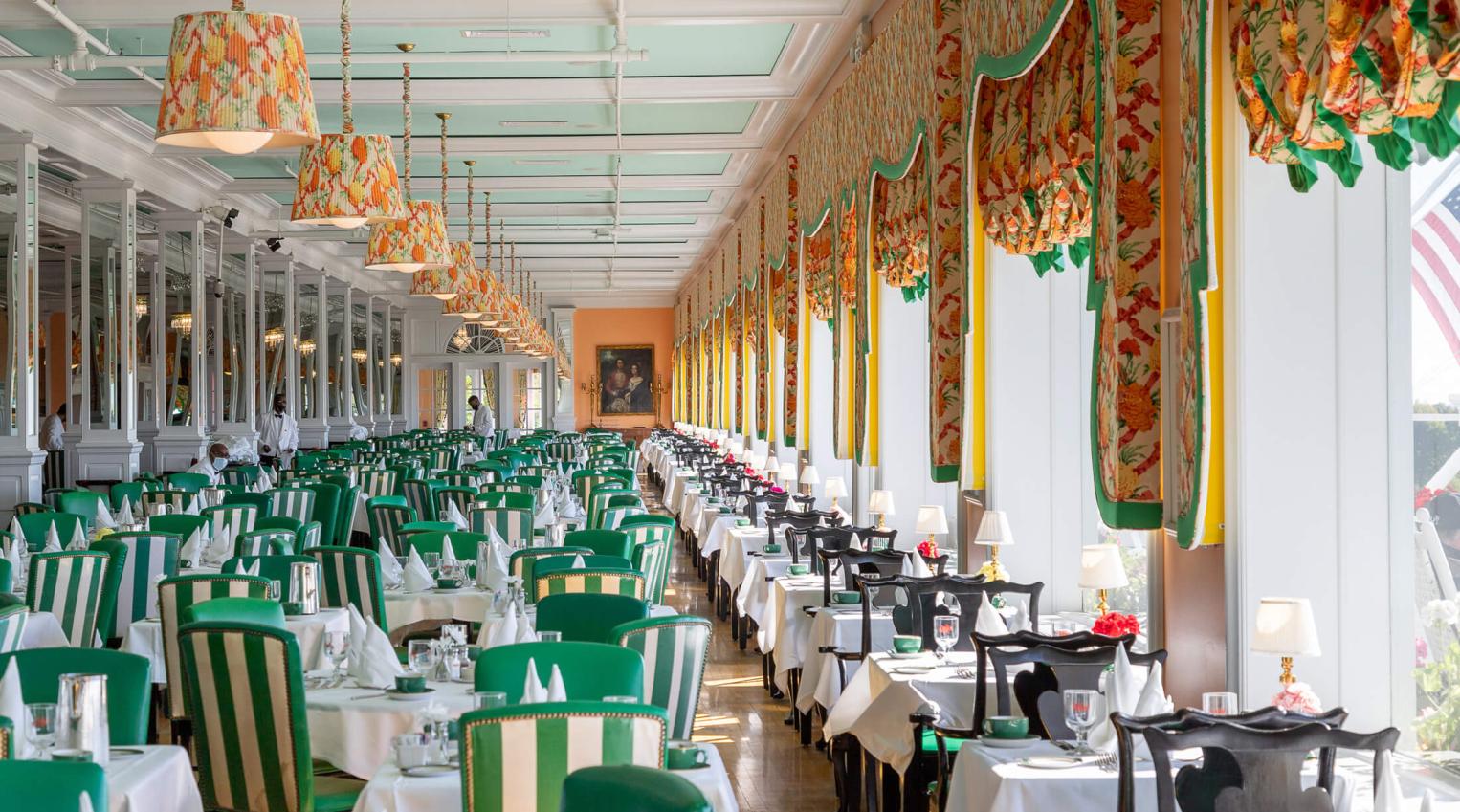 Main Dining Room with green accent chairs.