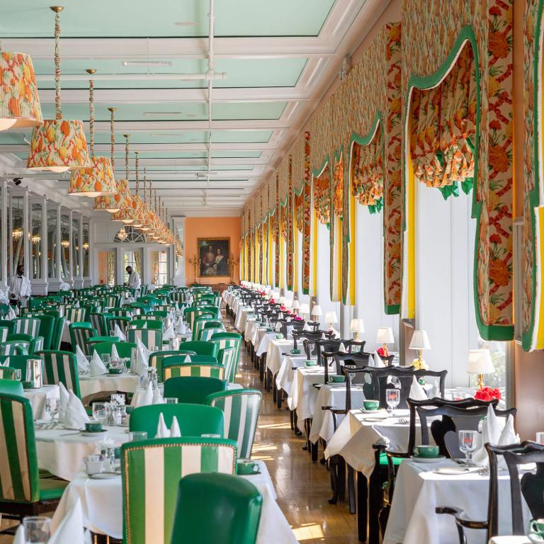 Main Dining Room with green accent chairs.