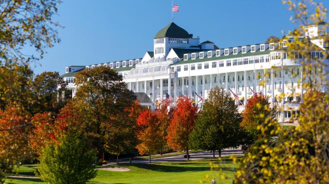 White building surrounded by trees at the Grand Hotel.